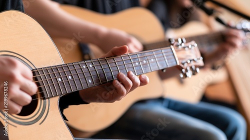 Hands playing acoustic guitars in music lesson, instrument practice and learning concept