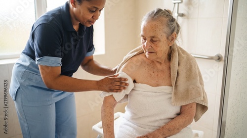 Elderly Healthcare Worker Assisting With Washing
