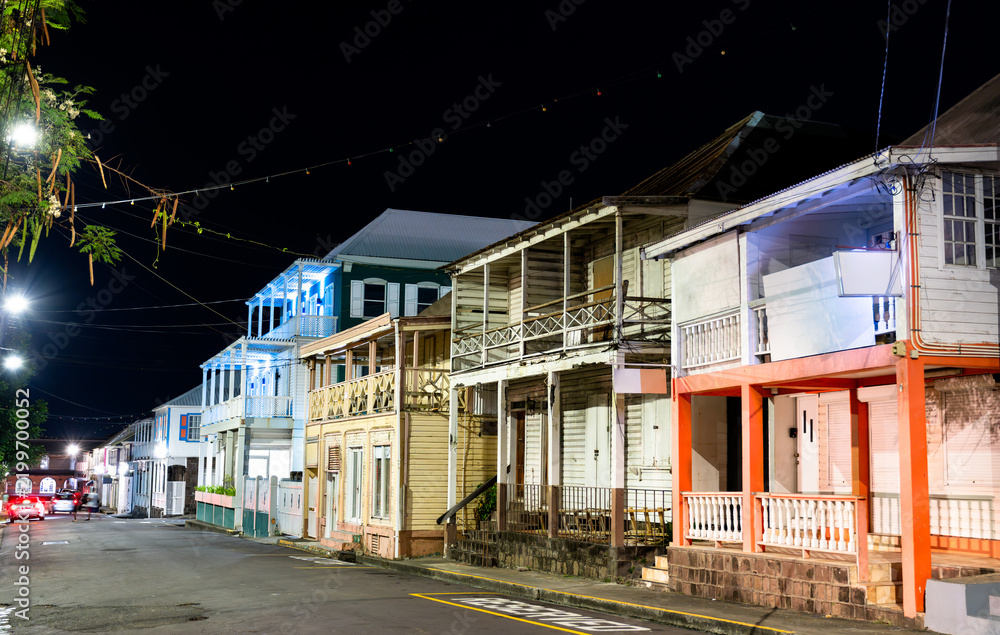 Obraz premium Traditional wooden colonial buildings illuminated at night on West Independence Street in Basseterre, Saint Kitts and Nevis.