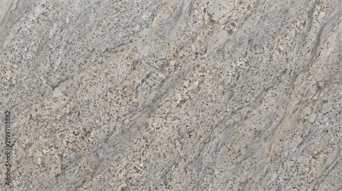 Polished grey granite stone slab texture with natural wavy pattern