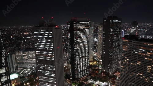 Night aerial view of illuminated skyscrapers in downtown Tokyo.