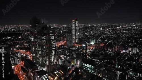 Bright city skyscrapers tower over a glowing night metropolis