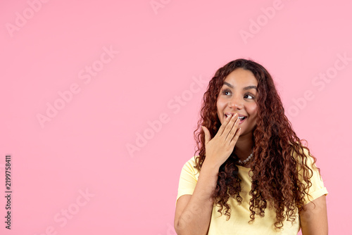 Young black woman showing surprise looking up