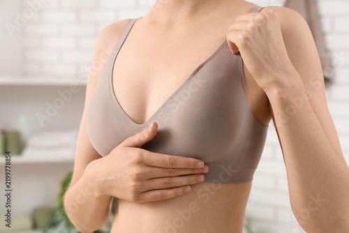 Cuadro en lienzo Breast cancer awareness and self-examination, woman checking for lumps in a bra