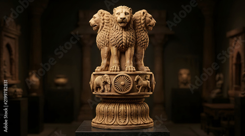 Ancient stone sculpture of the Lion Capital of Ashoka displayed in a museum gallery.