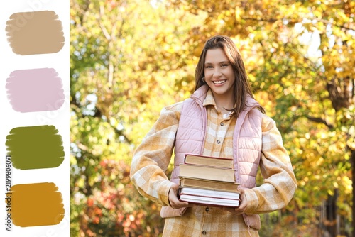 Education and academic success, happy student holding a stack of books in an ...