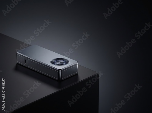 Sleek rectangular metallic device with blue glowing interface on a dark surface