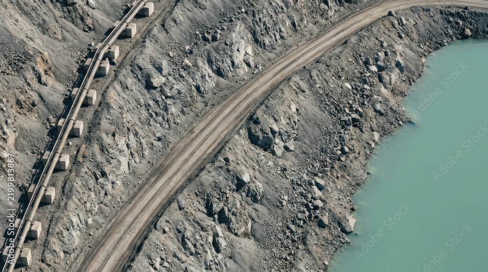 Obraz premium Aerial view of a large open pit mine with conveyor belt