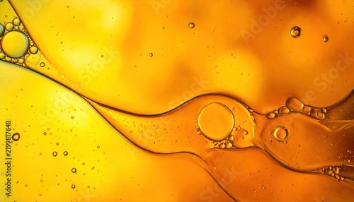Macro golden oil bubbles and flowing fluid waves background
