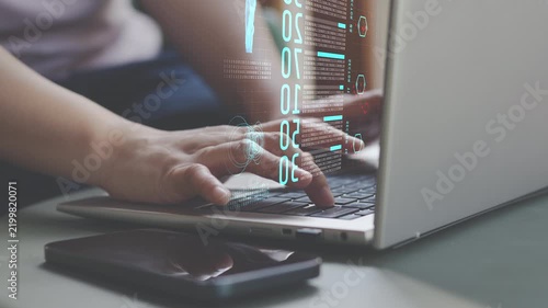Hands typing on laptop with digital data interface,  cybersecurity, software development, data processing, programming and secure information technology for modern online business.