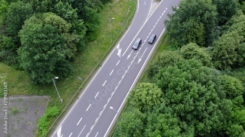 Aerial View of a Busy Highway Interchange with Cars Moving Through Lush Green Surroundings
