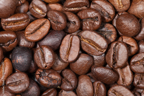 Macro shot of roasted coffee beans background texture.