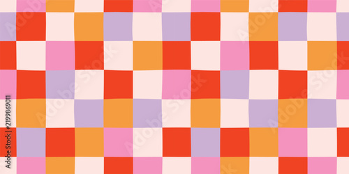 Playful checkered seamless pattern with colorful hand drawn red, orange, pink, and purple squares. Groovy retro vector background.