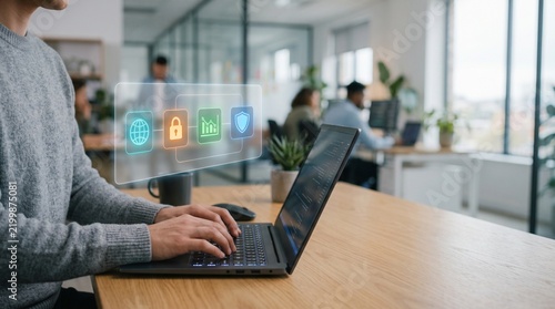 Cybersecurity data protection concept, professional using laptop with digital security icons, modern office workspace with network safety interface