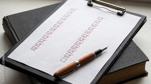 Paper checklist featuring multiple boxes marked with red checkmarks, representing business emergency preparedness, organization, planning, safety, and readiness