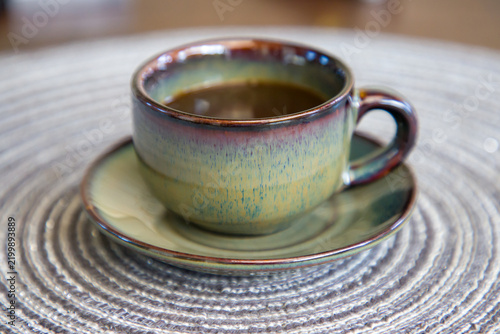 Quadro su tela Cup of coffee on the table in a cafe. Selective focus.