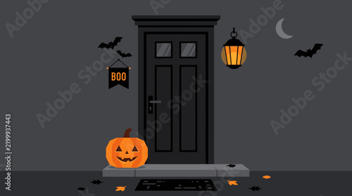 Boo sign on a front door decorated for halloween with a carved pumpkin