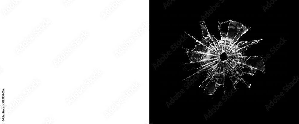 Fototapeta premium Shattered glass bullet hole on black background, realistic broken glass texture with radial cracks, damaged window pane overlay for composite design