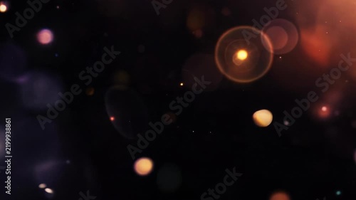 Warm cinematic lens bokeh floating on black seamless loop