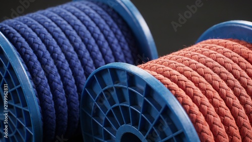 Close Up of Blue and Orange Braided Textile Rope Coils on Plastic Reels