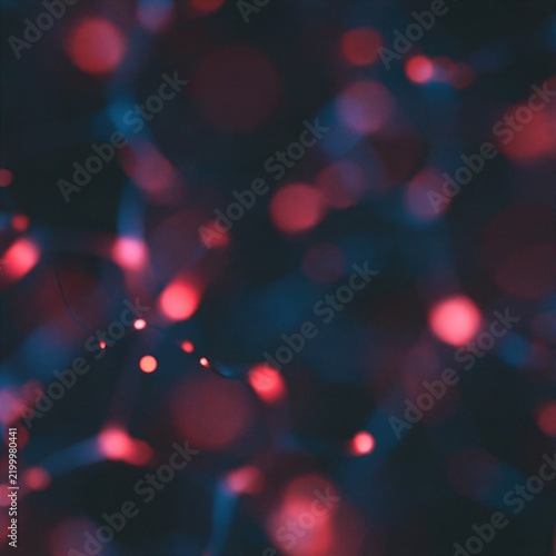 Abstract dark bokeh background with blurred glowing lights