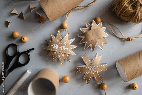 DIY gift handmade Christmas tree decorations: toy snowflakes made from toilet paper rolls. paper craft for kids. create art for children.