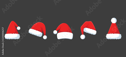 Set of five different santa claus hats with white fur trim a dark background