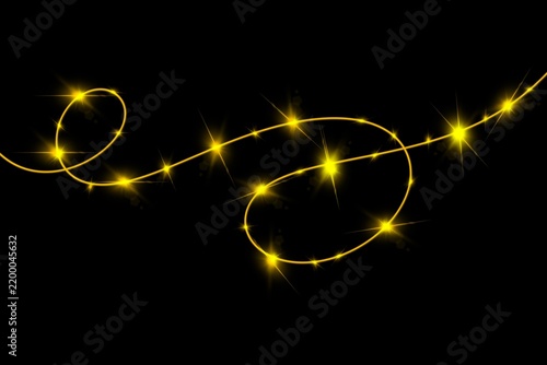Glowing Christmas fairy lights garland with sparkling golden warm bulbs isolated on black background