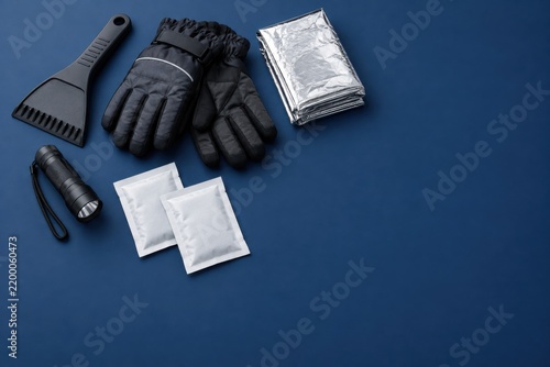 Compact winter car emergency accessories on navy background