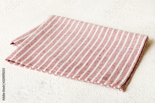 top view with red empty kitchen napkin isolated on table background. Folded cloth for mockup with copy space, Flat lay. Minimal style