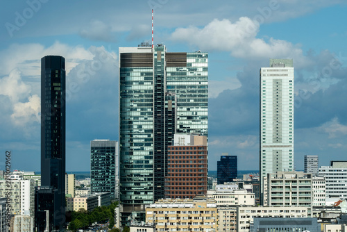 Modern skyline of Wola business district around Rondo Daszyńskiego in Warsaw, Poland, with contemporary office towers rising under a bright cloudy sky