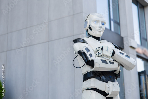 Bionic humanoid standing with crossed arms