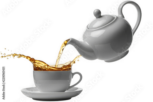 High contrast product photography of tea pouring from teapot into cup splash