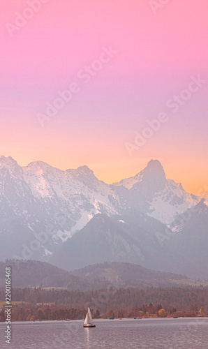 Fotografie Vertical view with Sunset Over Snow-Capped Mountain Range and Rural Landscape of
