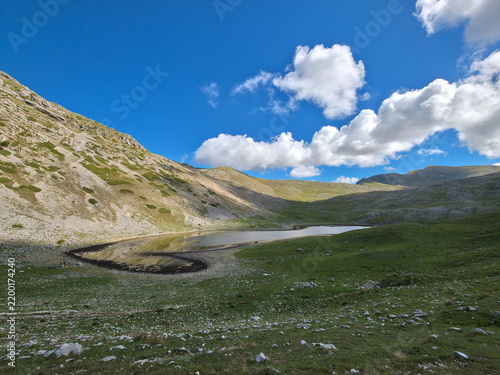 Lago della Duchessa alpine lake in the regional park of regional park of Sirente-Velino, Lazio, Italy. Beautiful mountain landscape scenery under blue sky