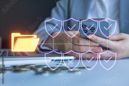 Digital security in focus with a person using a smartphone and a laptop in a modern setting