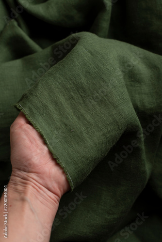 Hand Holding Olive Green Linen Fabric Edge