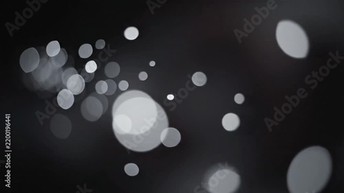 Falling Light Particles Moving Through Dark Background in Slow Motion
