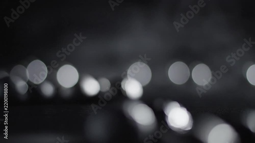Closeup of blurred shiny objects in dark low-light environment