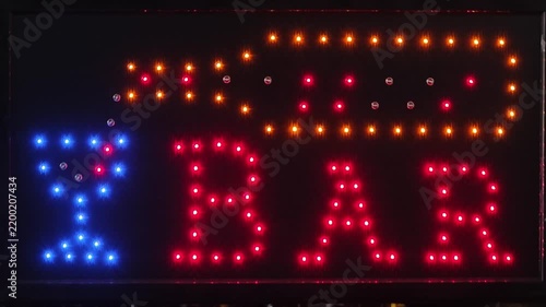 a BAR LED lighted sign featuring a glowing bottle pouring a drink into a blue cocktail glass next to the word BAR in red LEDs