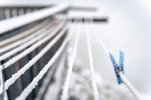 Iced clothespin on rope, mountain peak rising from clouds, Sölden, Ötztal, Tyrol, Austria