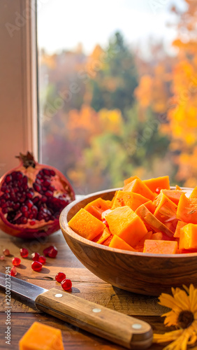 Cozy kitchen still life with pumpkin slices on rustic wooden table for web banner.