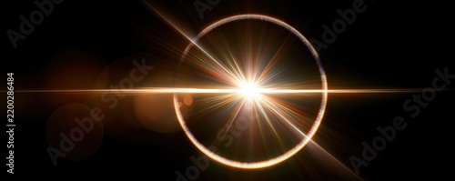 Bright lens flare creating circular light ring on black background
