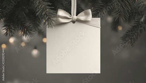 Gift Tag Hanging From a Christmas Tree Branch With Lights in the Background