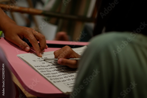 Mother Supporting Daughter Education and Homework at Wooden Table