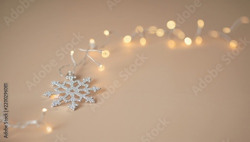 Sparkling Snowflake Ornament With Warm Lights on a Simple Background