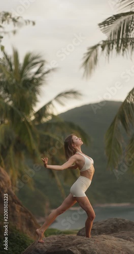 Young Woman Dancing on Tropical Rocks at Golden Hour