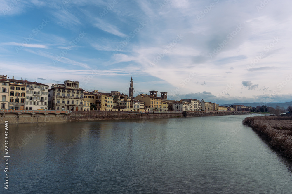Fototapeta premium Scenic view of historical buildings along the Arno River in Florence Italy
