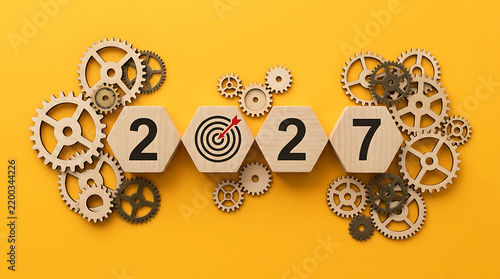 Strategy 2027 concept with wooden blocks, target and gears on yellow background