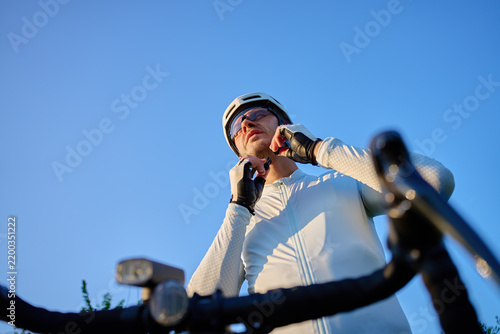 Cyclist fastening helmet before bike training